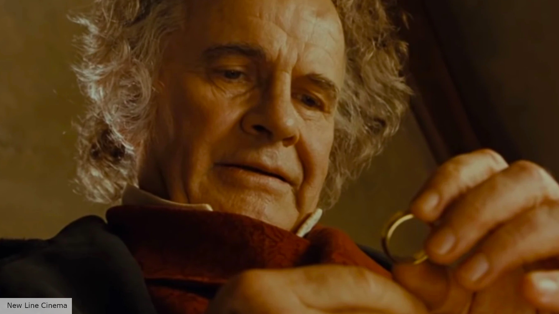 Bilbo Baggins holding the One Ring, struggling to let it go, from The Lord of the Rings: The Fellowship of the Ring (2001)